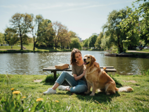 Dog by woman in park